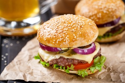 Delicious burger with beef, cheese and vegetables